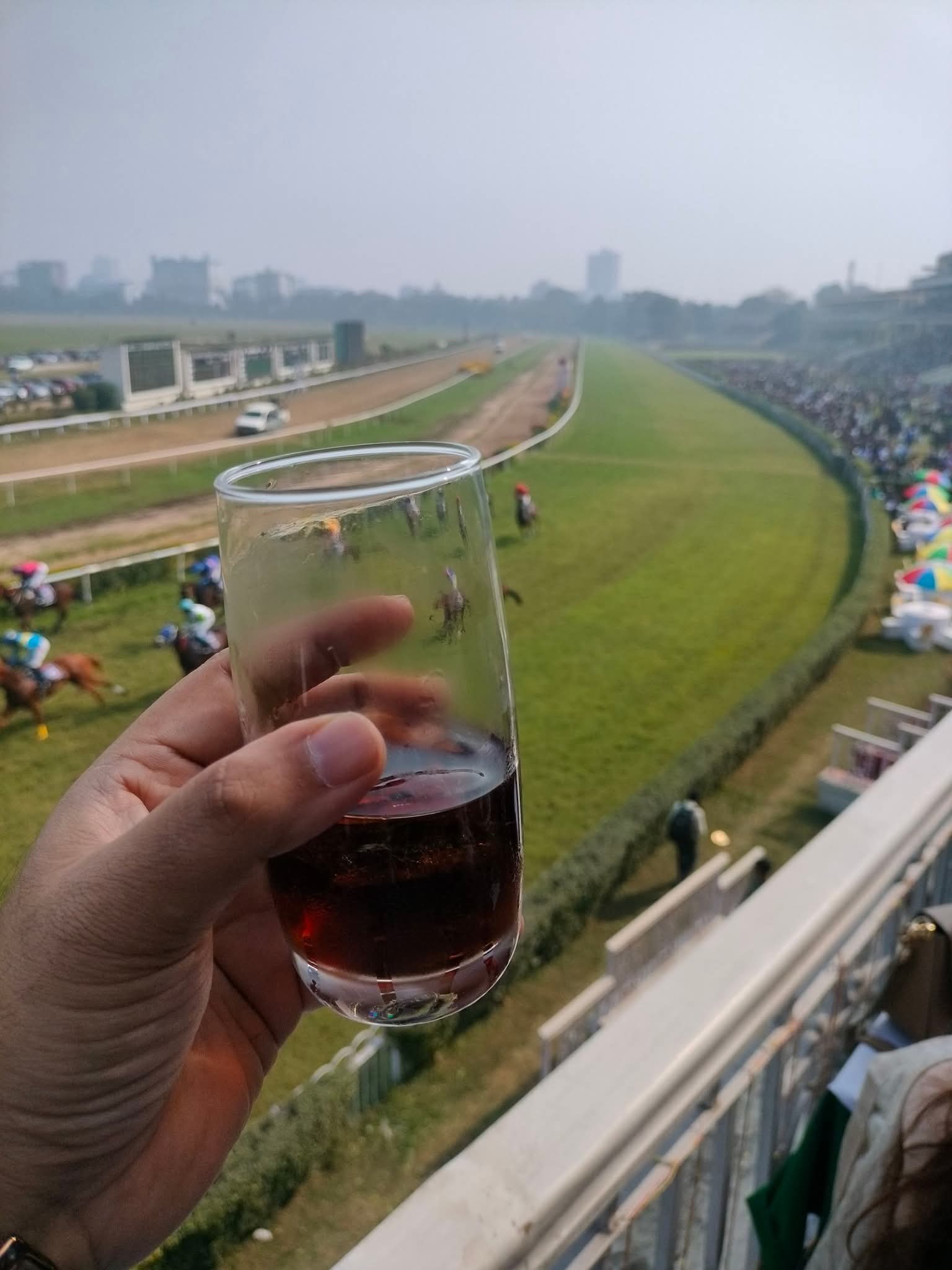 A glass of wine overlooking the racecourse